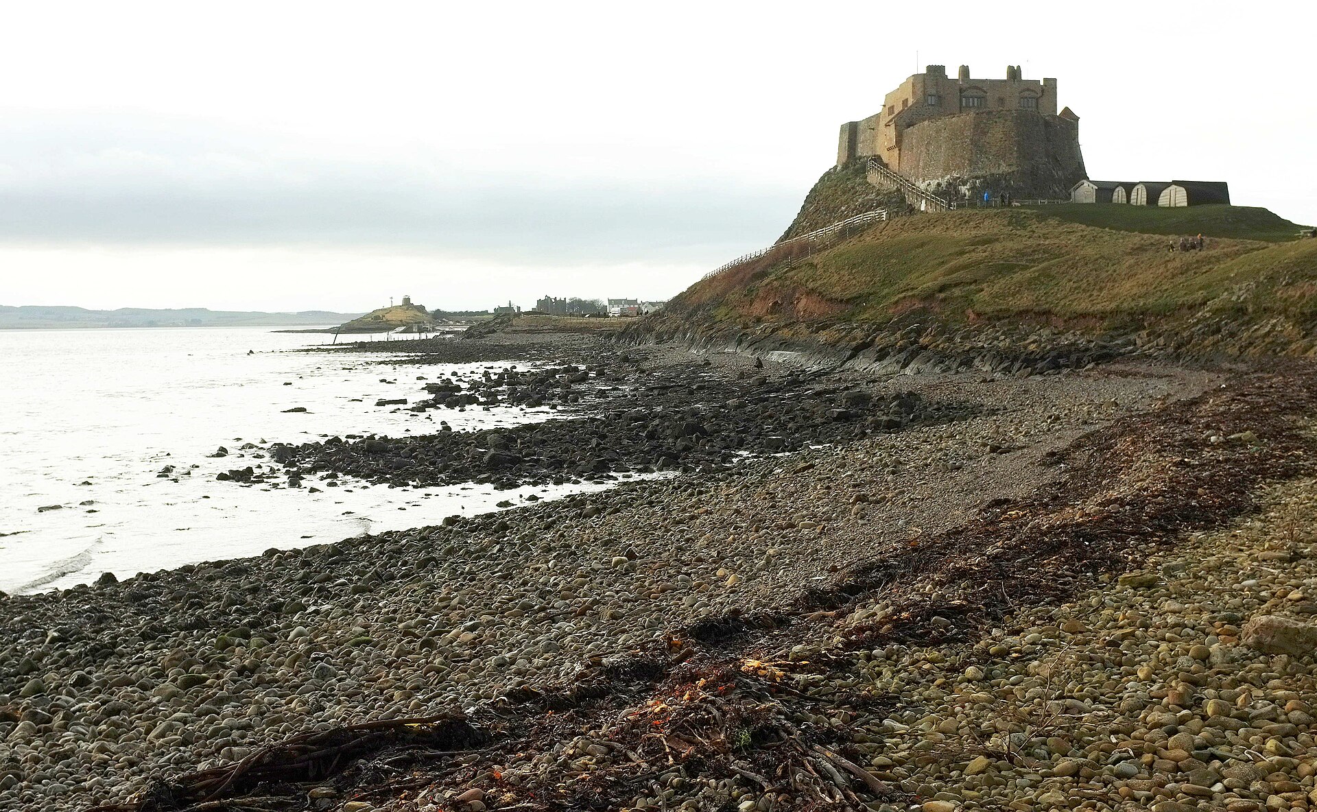 Lindisfarne Castle standing on its rocky crag above the shore of Holy Island, Northumberland